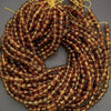 Coiled string of brown beads on a gray background