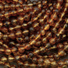 Close-up of amber-colored beads on a dark background