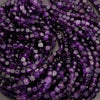 Close-up of purple beads on a string