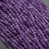 Close-up of purple beads on a gray background