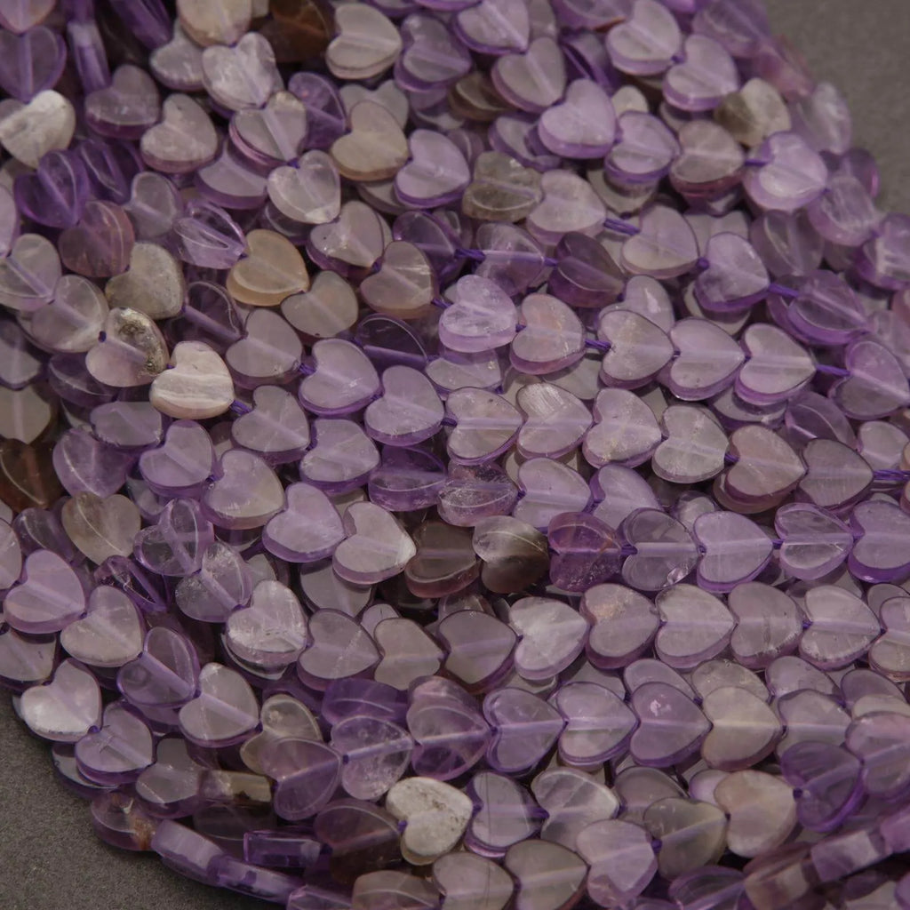 Close-up of purple heart-shaped beads on a gray background