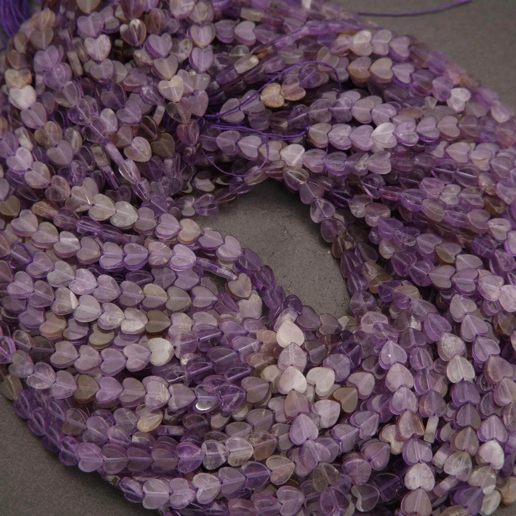 String of purple heart-shaped beads on a gray background