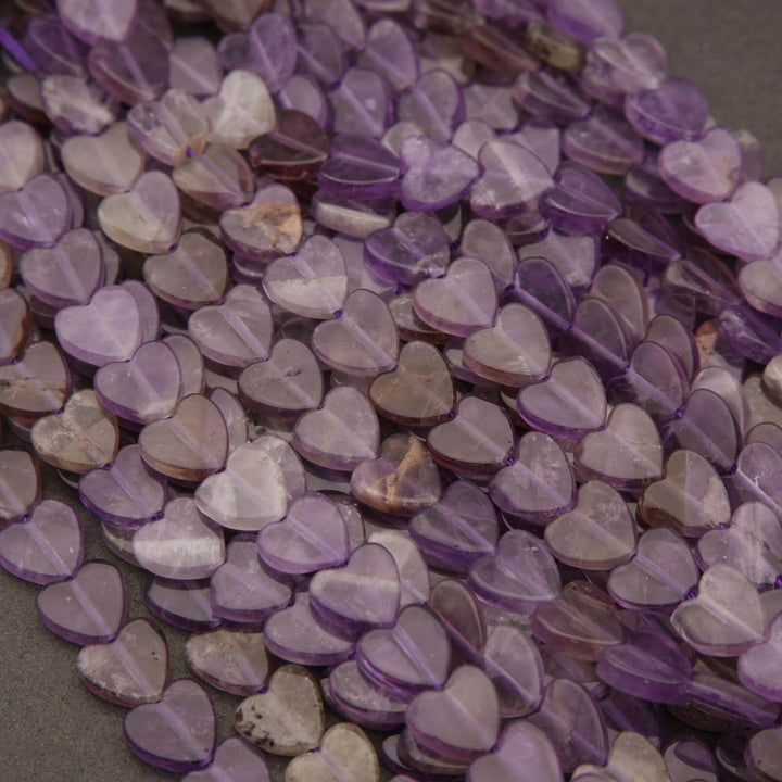 Close-up of purple heart-shaped beads on a dark surface