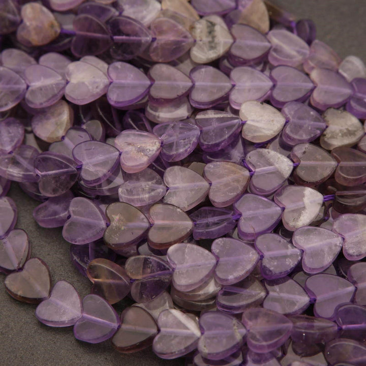 Close-up of purple heart-shaped beads on a dark surface