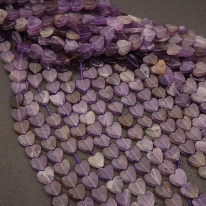 String of purple heart-shaped beads on a dark surface