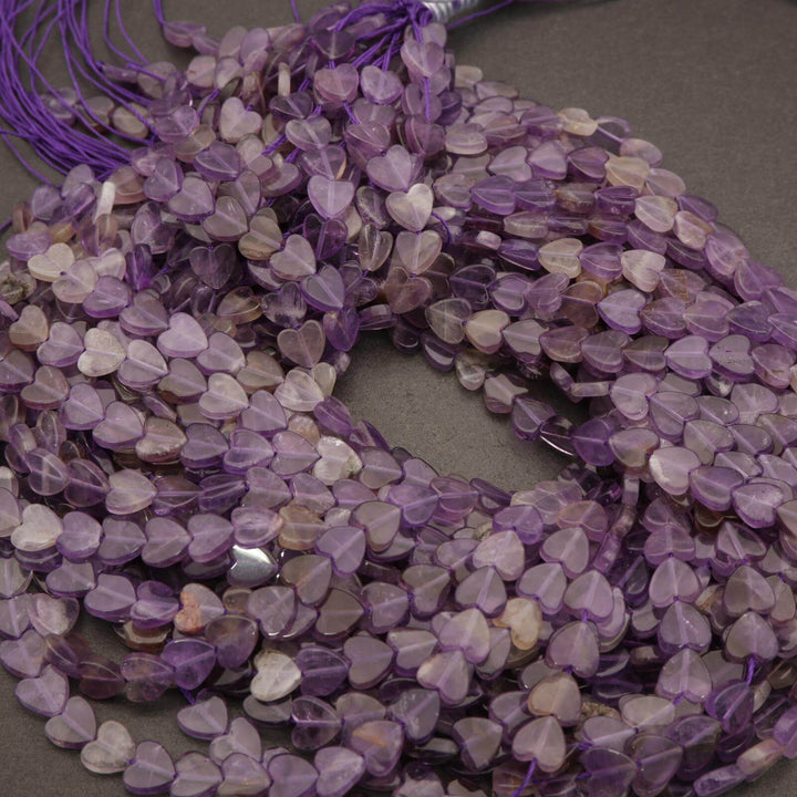 Purple heart-shaped beads on a gray surface