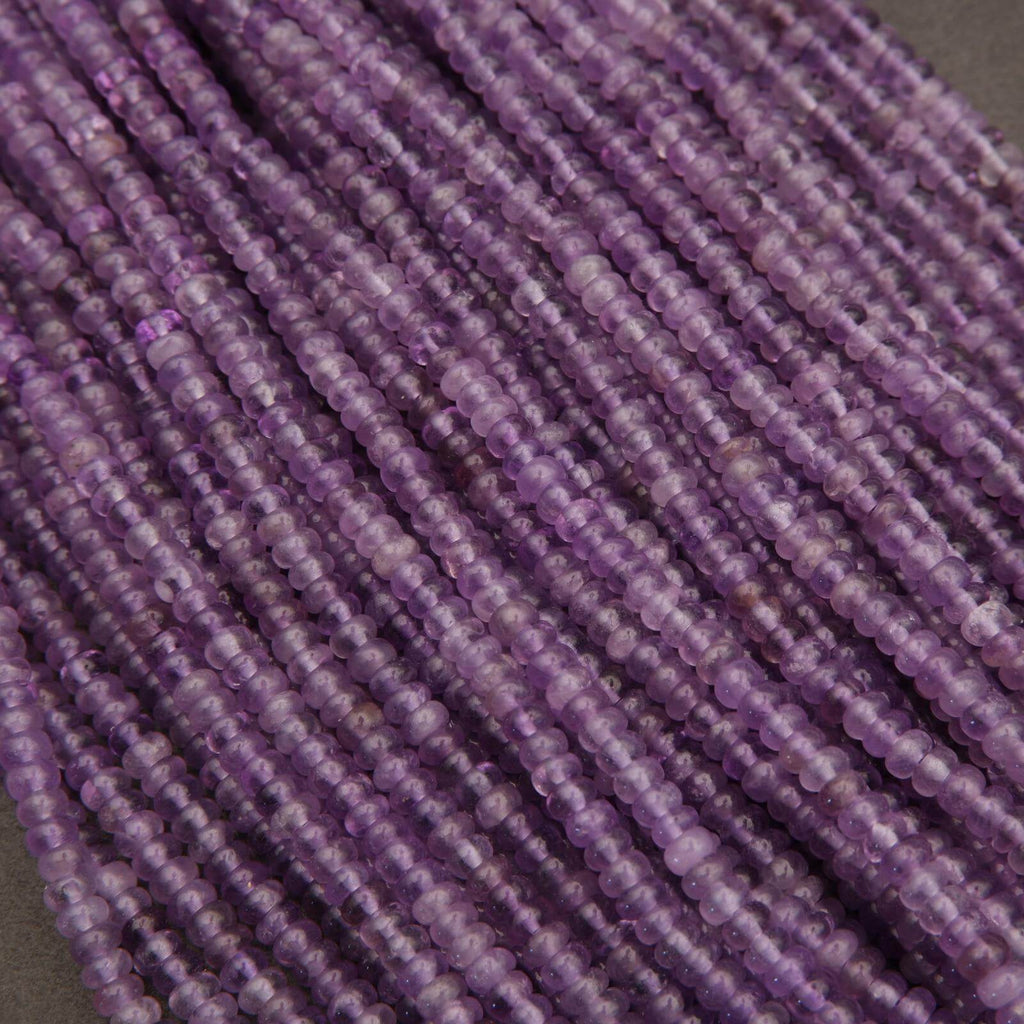 Close-up of purple beads on a gray background