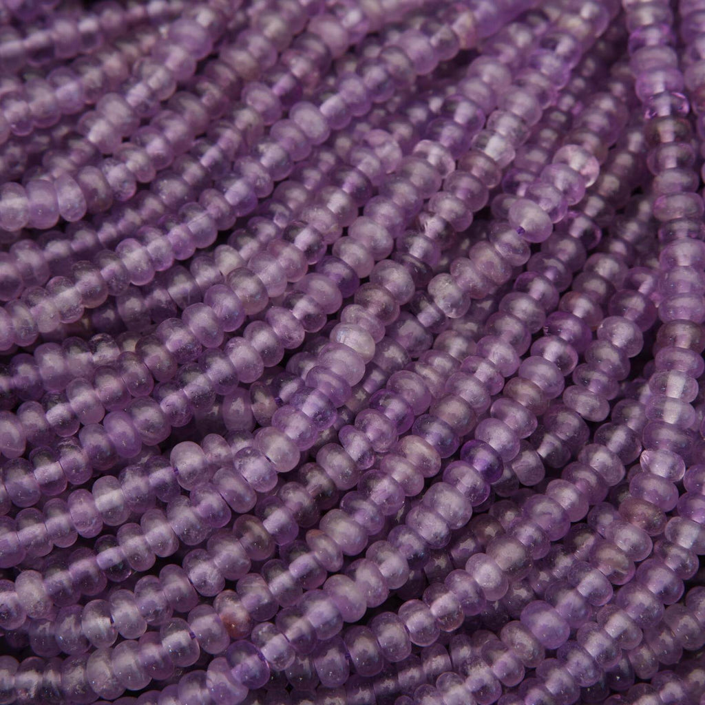 Close-up of purple beads on a string