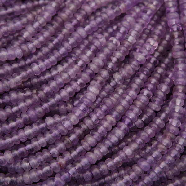 Close-up of purple beads on a string