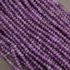 Close-up of purple beads on a gray background