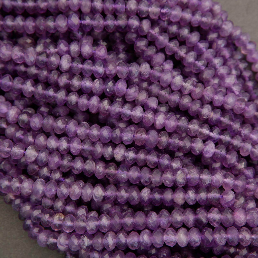 Close-up of a string of purple beads on a gray background