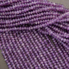 Close-up of purple beads on a string