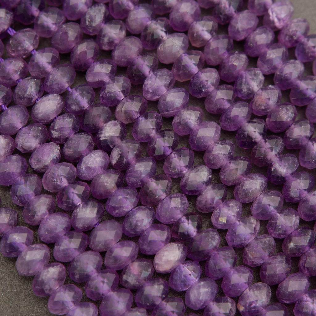 Close-up of purple faceted beads on a gray background