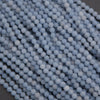 Close-up of light blue beads on a dark background