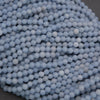 Close-up of a pile of light blue spherical beads.