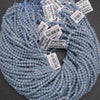 Blue beads with price tags on a dark background
