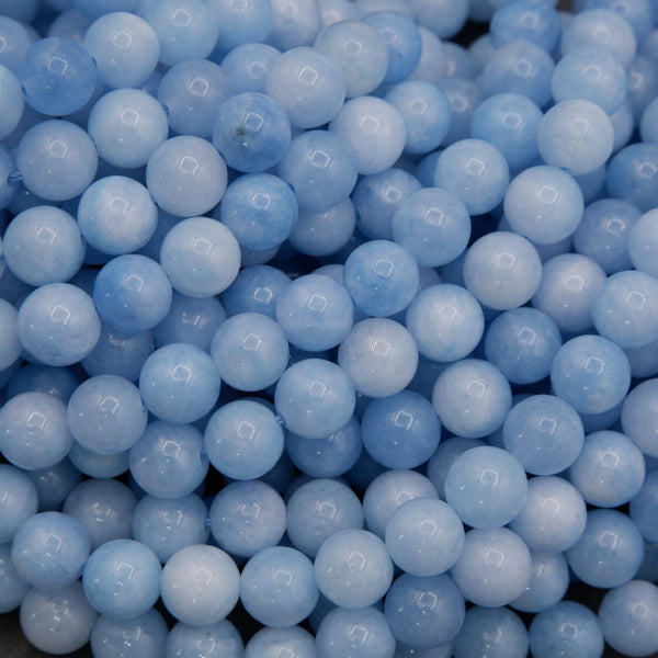 Aqua jade round beads in soft light blue tones, polished and strung