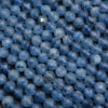 Close-up of blue beads on a textured surface