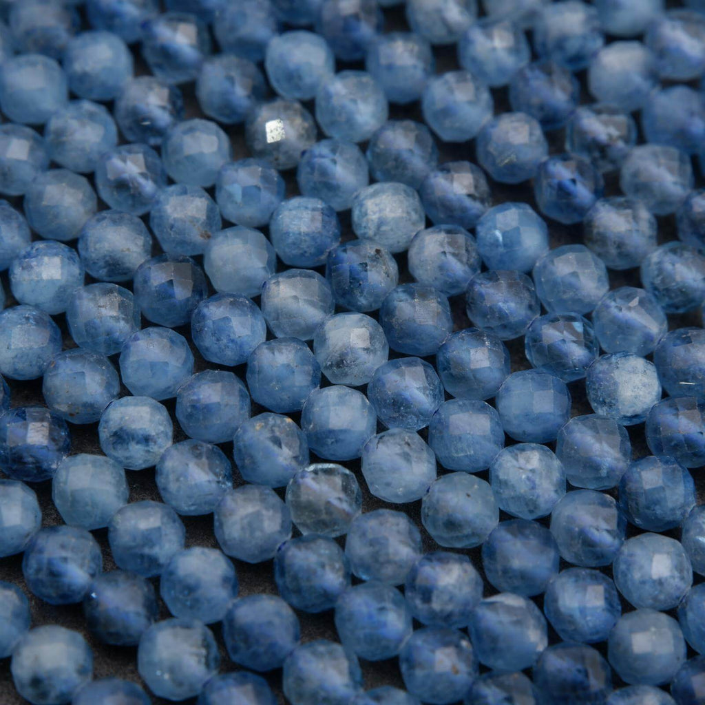 Close-up of blue beads on a textured surface