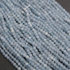 Close-up of light blue beads on a dark background