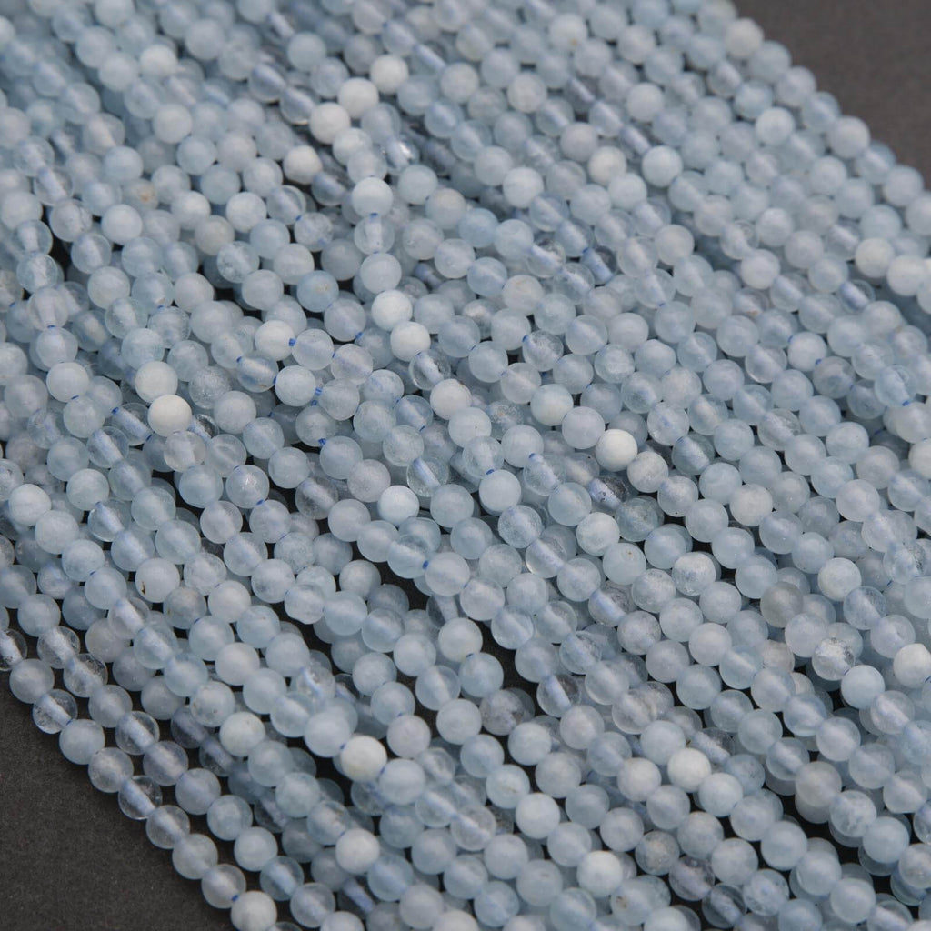 Close-up of light blue beads on a dark background