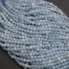 Close-up of a string of light blue beads on a dark background