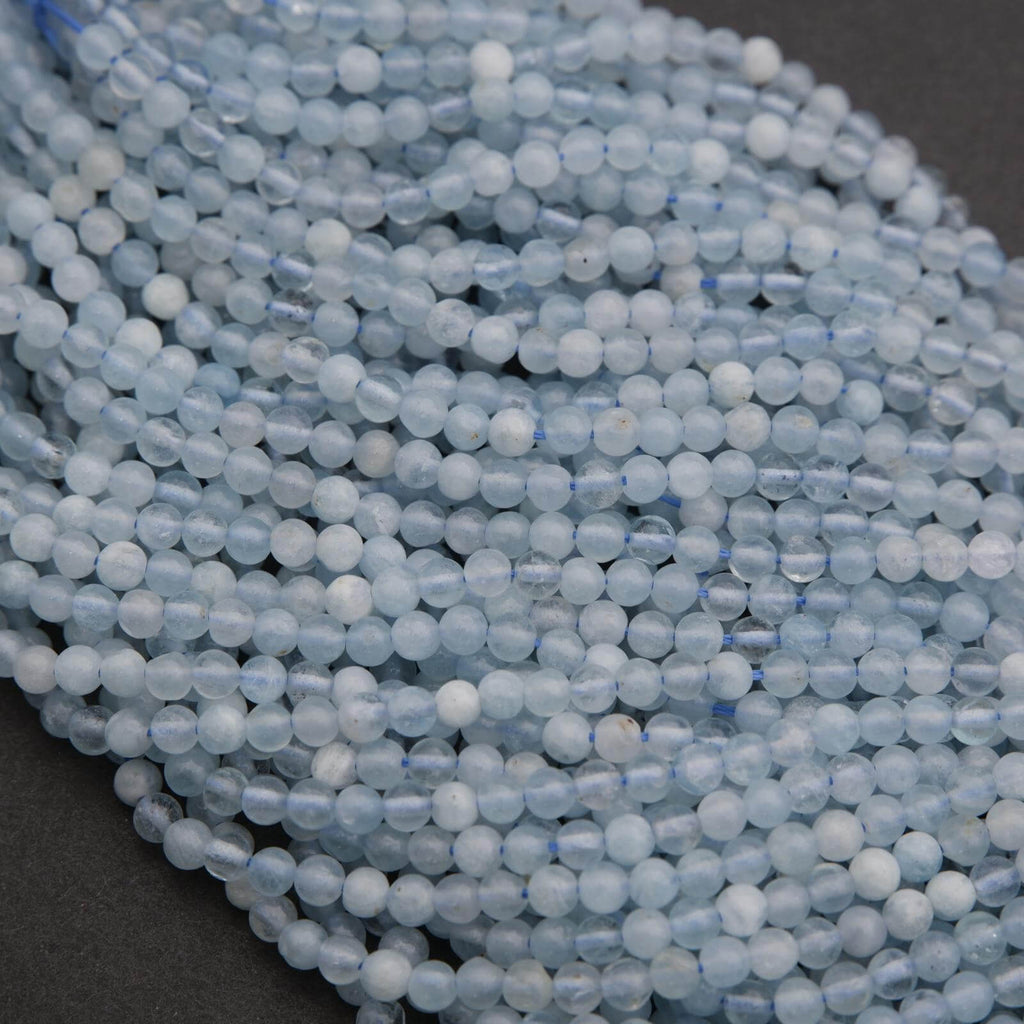Close-up of a string of light blue beads on a dark background