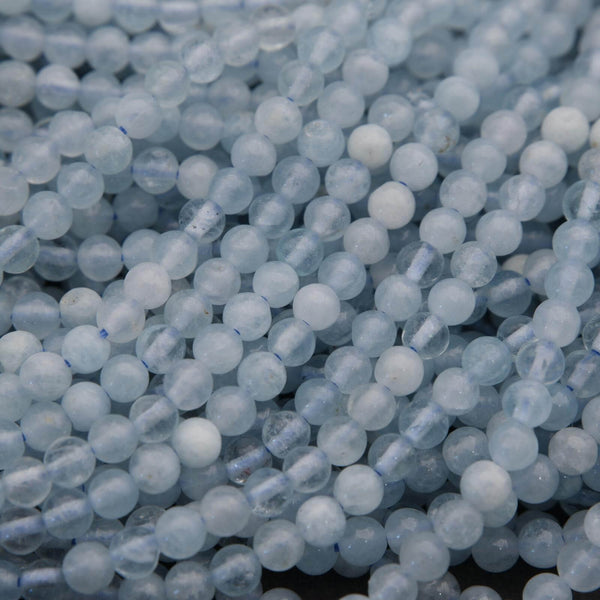 Close-up of light blue beads on a dark background