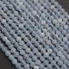 Close-up of light blue beads on a dark surface