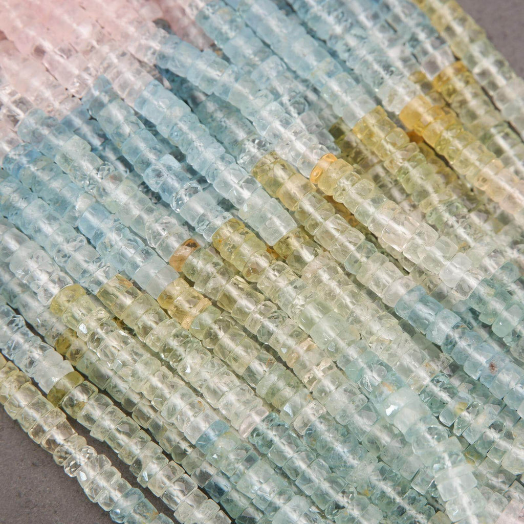 Close-up of multicolored gemstone beads on a gray background