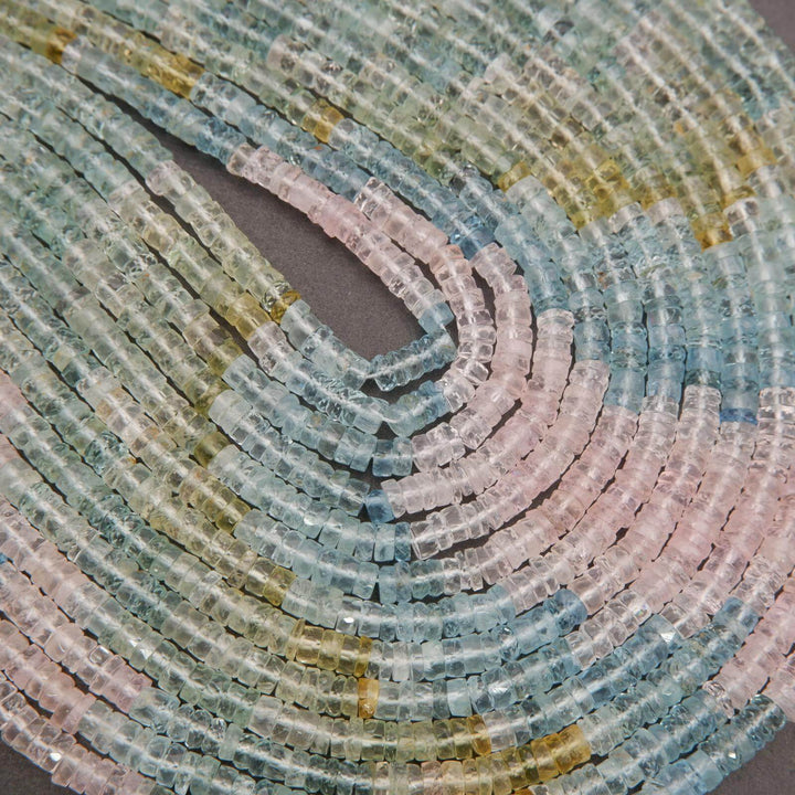 Close-up of multicolored beryl beads arranged in a pattern.