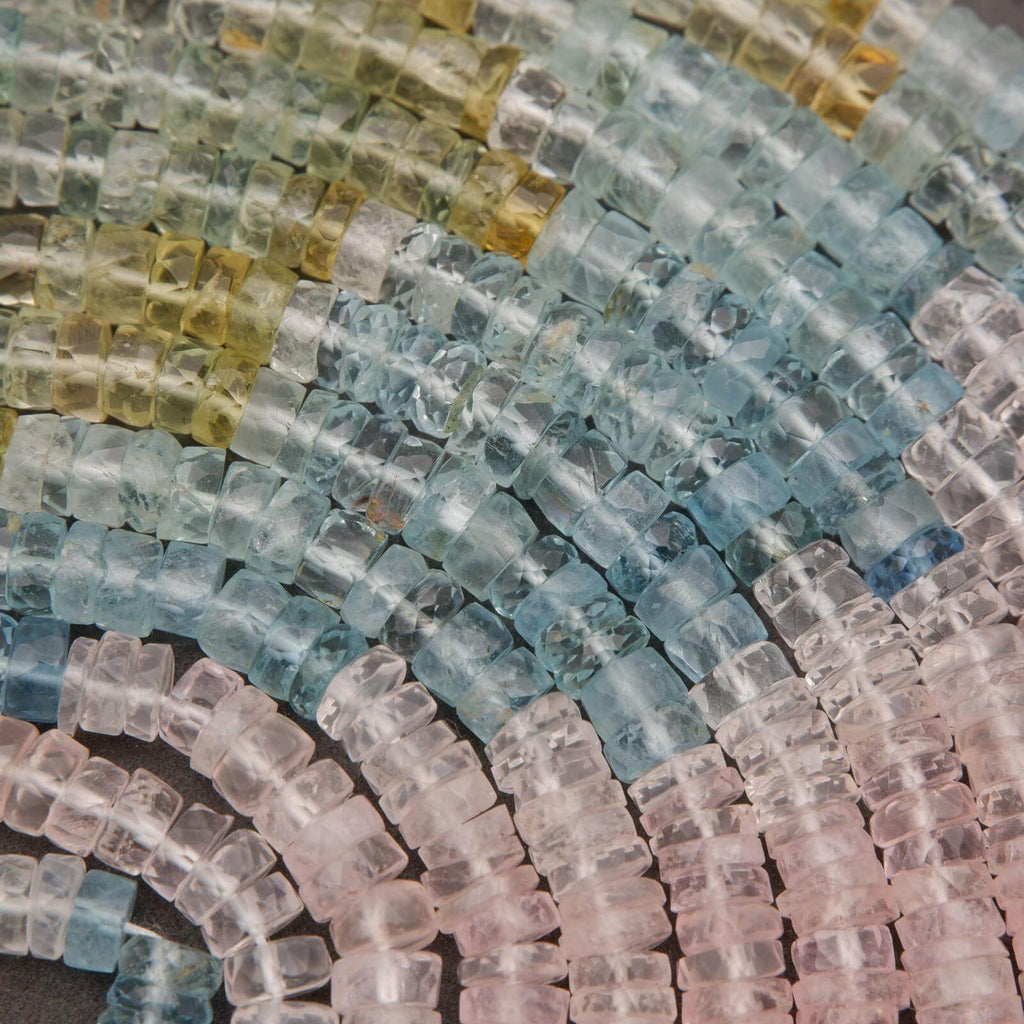 Close-up of multicolored beryl beads arranged in a pattern.