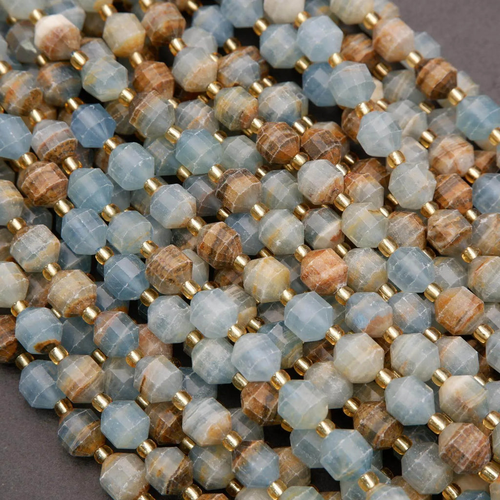 Close-up of a string of multicolored beads with gold spacers on a gray background
