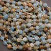 Close-up of multicolored beads with gold spacers on a dark background