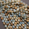 Close-up of a string of multicolored beads with gold spacers on a gray background