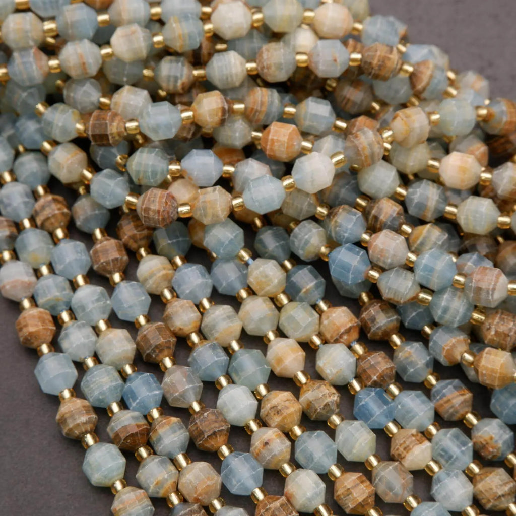 Close-up of a string of multicolored beads with gold spacers on a gray background