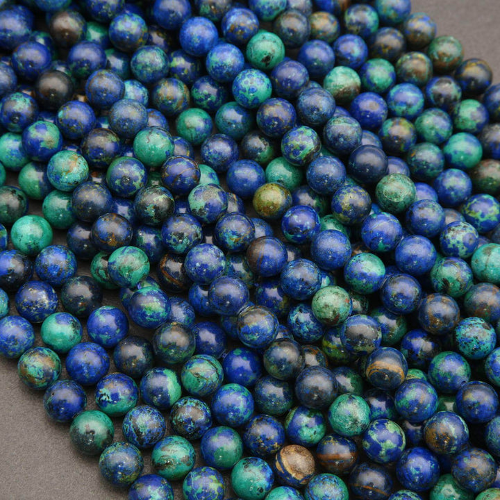 Close-up of blue and green beads on a gray background