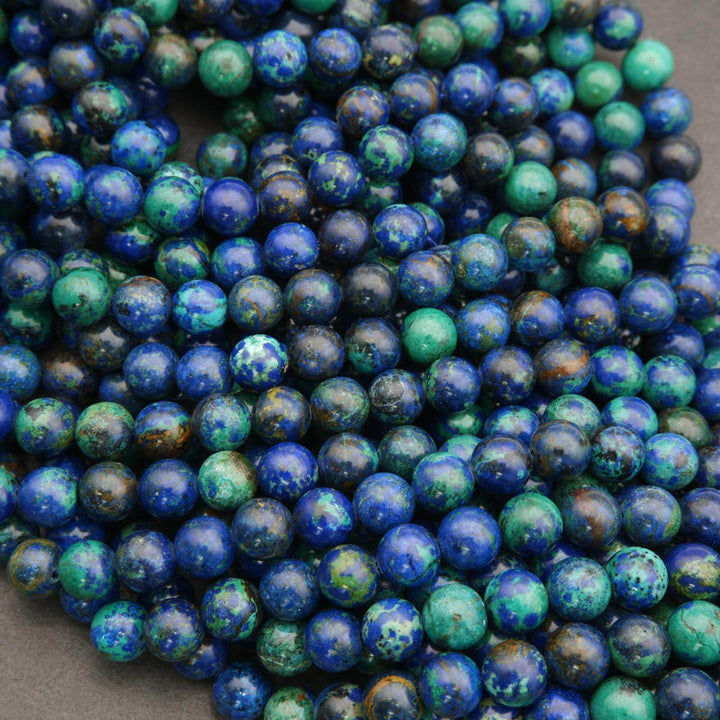 Close-up of blue and green marbled beads on a dark background