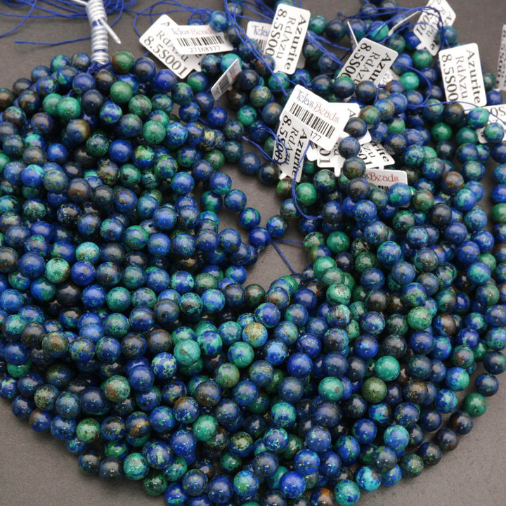 Beads in blue and green on a string with visible tags.