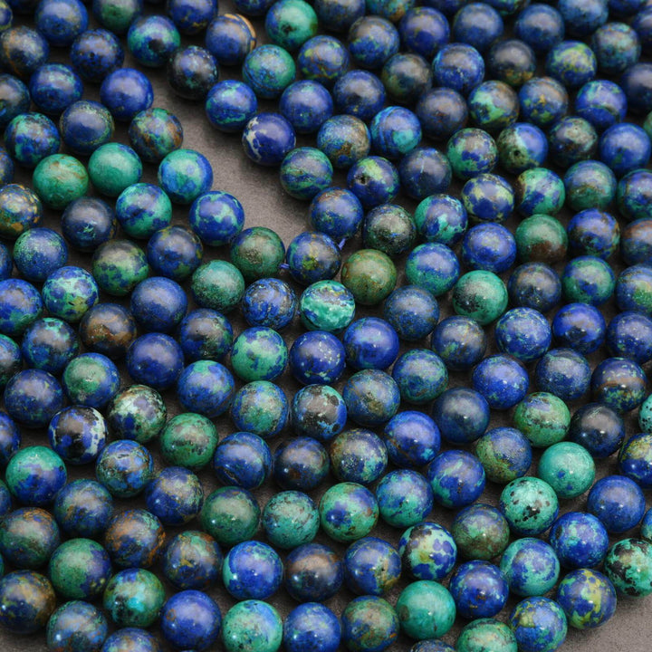 Close-up of blue and green round beads on a string