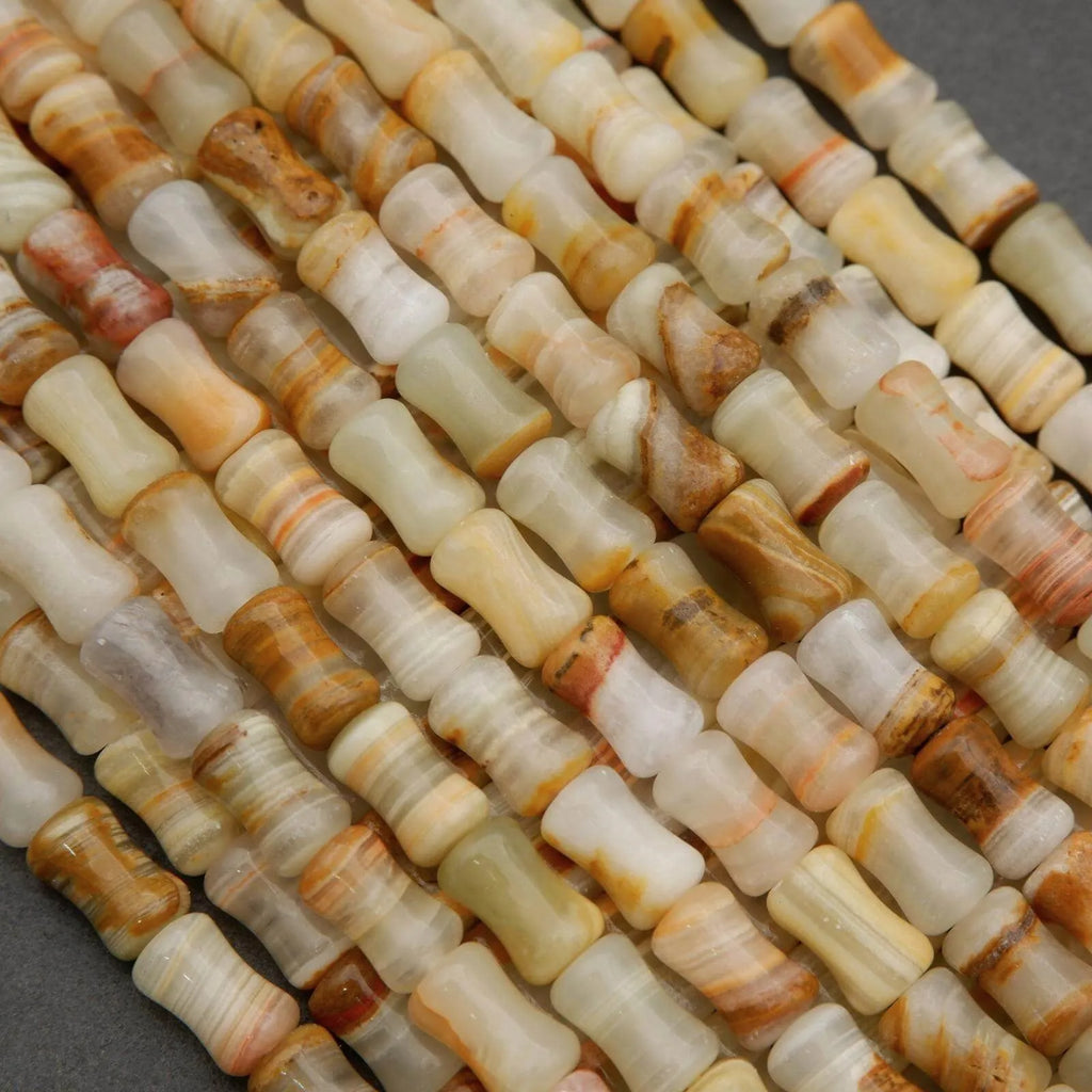 Striped calcite beads in pale green, beige, and golden tones for jewelry making