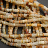 Bamboo-shaped calcite beads in soft green, cream, and honey hues with subtle stripes
