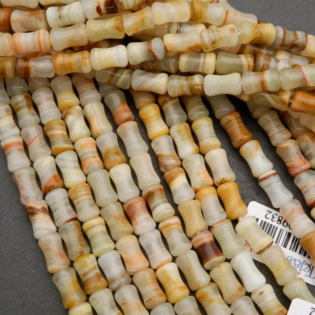 Natural calcite gemstone beads featuring layered patterns of green, ivory, and warm brown