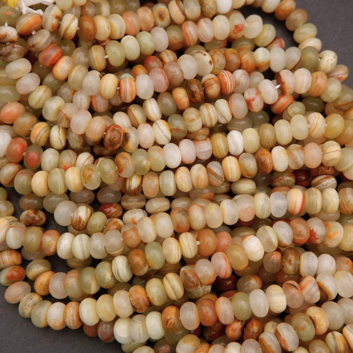 Strands of green banded calcite beads featuring layered bands in pale green, ivory, and tan tones.