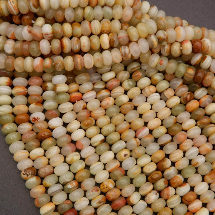Natural green banded calcite rondelles with smooth polish and organic color variation.