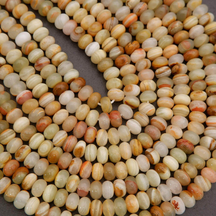 Multiple strands of green banded calcite rondelle beads with creamy neutrals and muted green tones.
