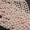 Close-up of a string of pink pearls on a dark background