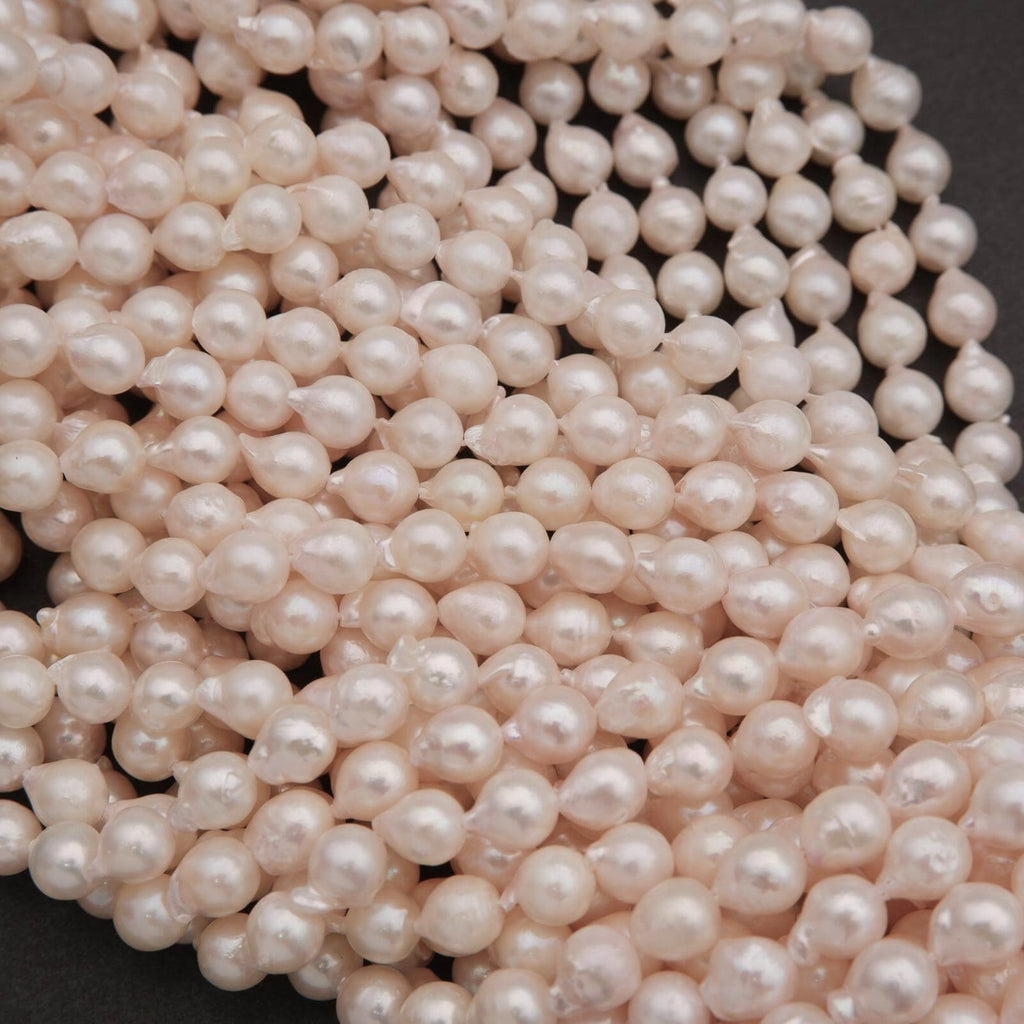 Close-up of a string of pink pearls on a dark background