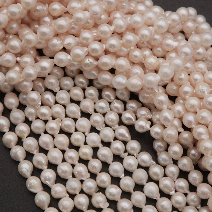 Close-up of a string of pink pearls on a dark background