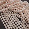 Close-up of a string of pink pearls on a dark background